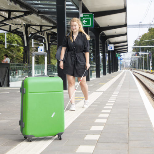 Anouk loopt op een geleidelijn tegen een koffer aan.